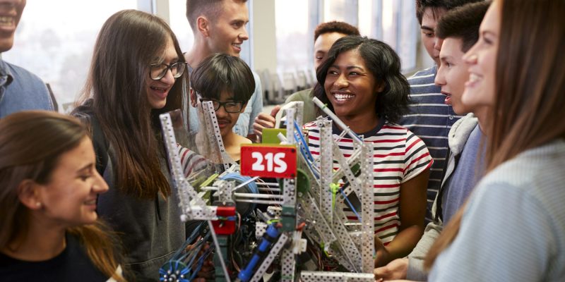 college-students-with-teacher-holding-machine-in-science-or-robotics-class.jpg college-students-with-teacher-holding-machine-in-science-or-robotics-class.jpg